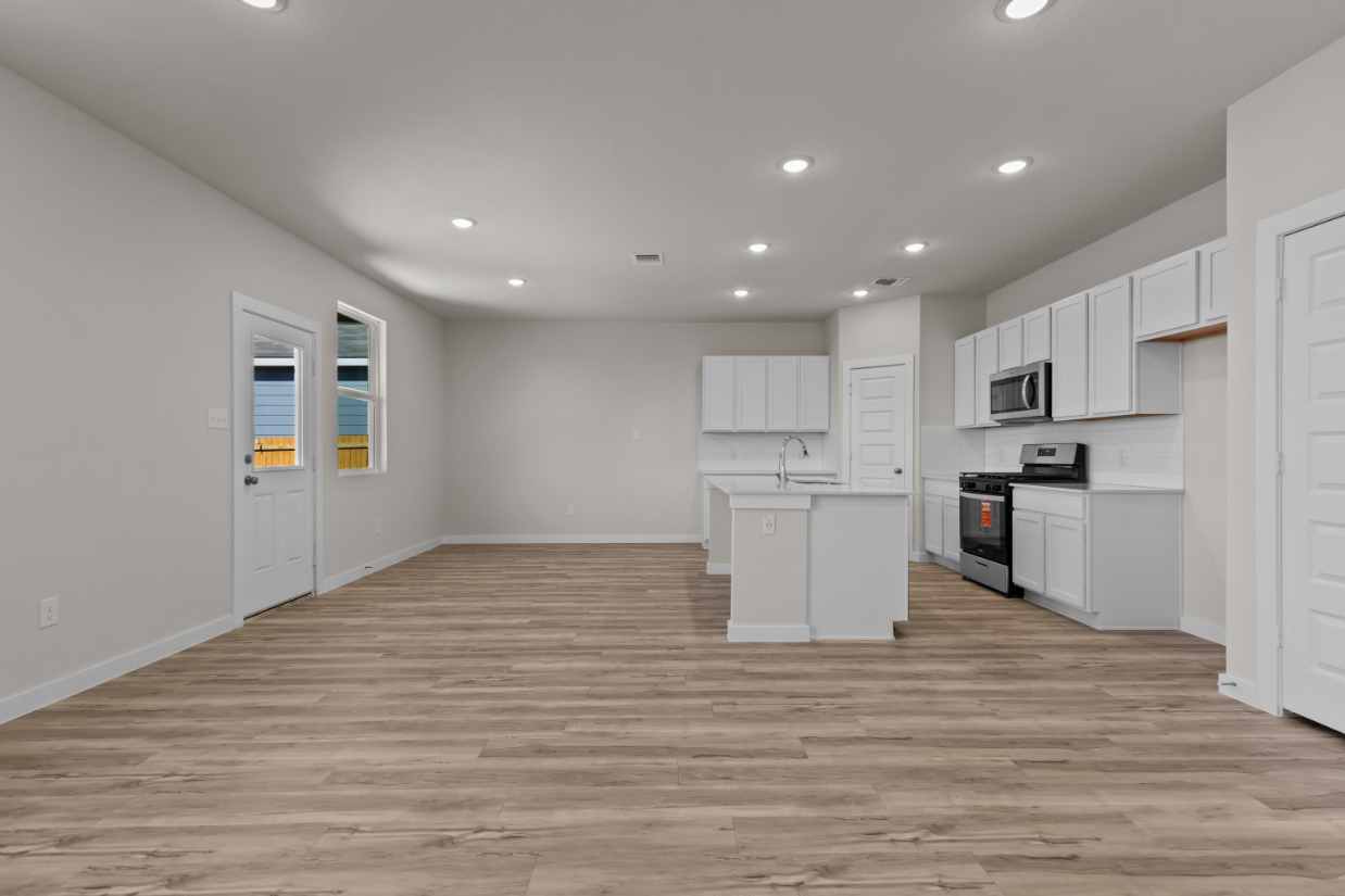 A kitchen with white cabinets.