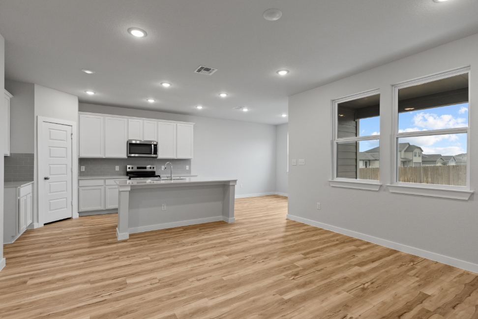 A kitchen with white cabinets.