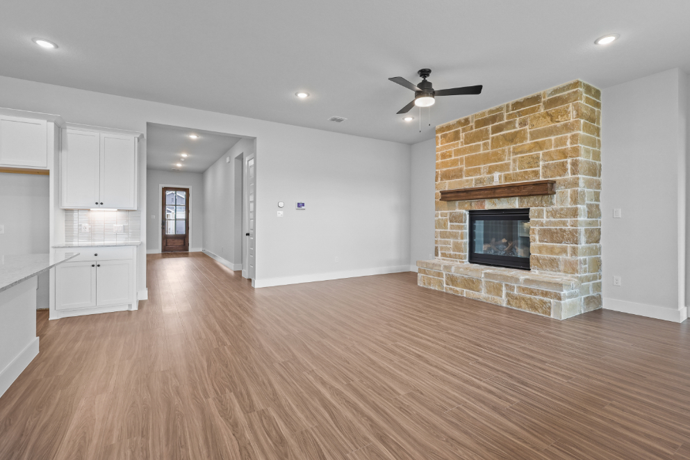 A large living room with a fireplace.