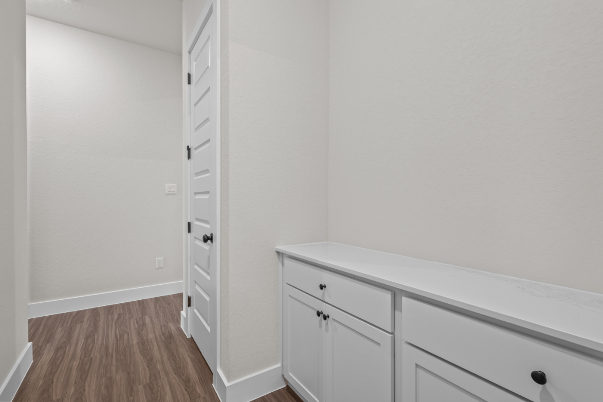 A white dresser in a room.