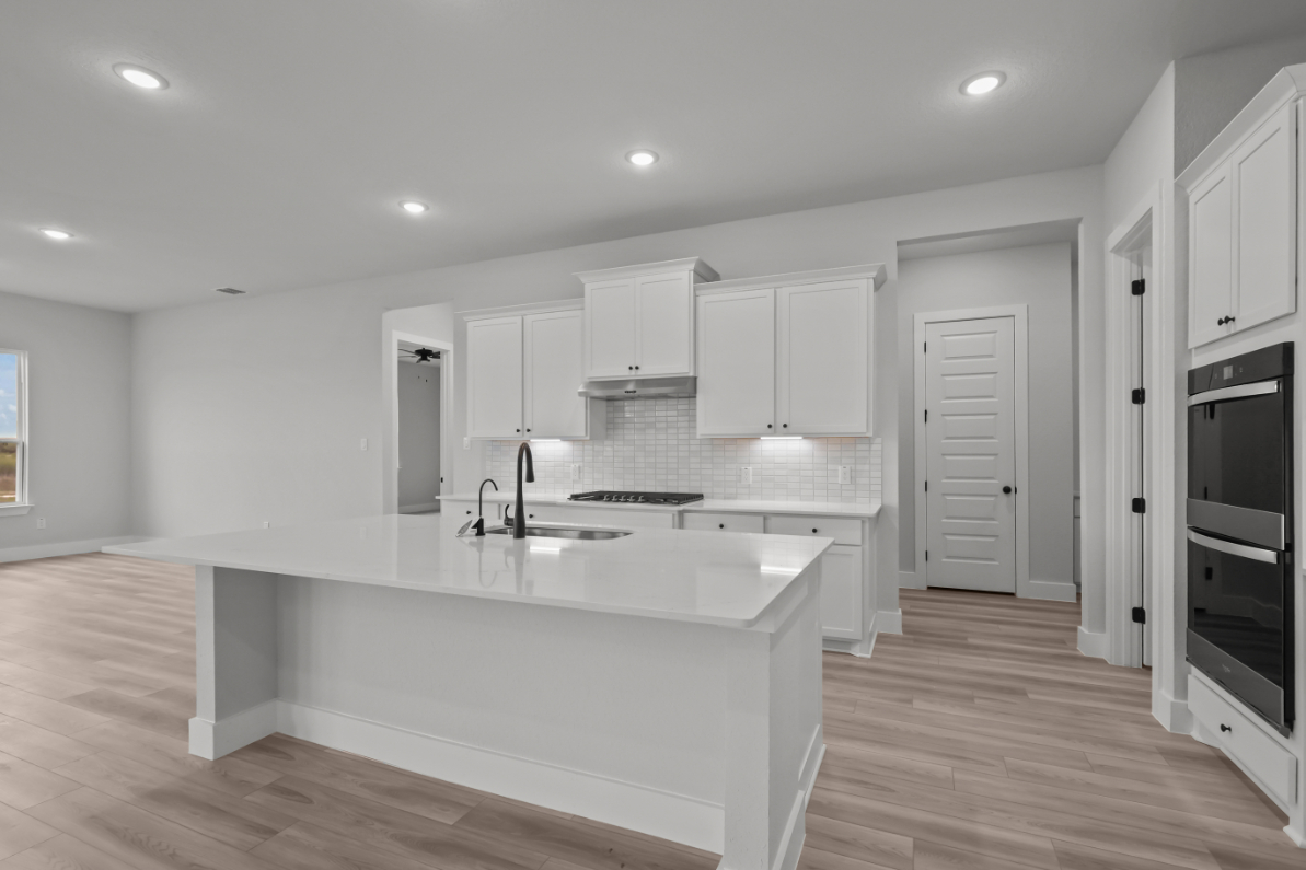 A kitchen with white cabinets.