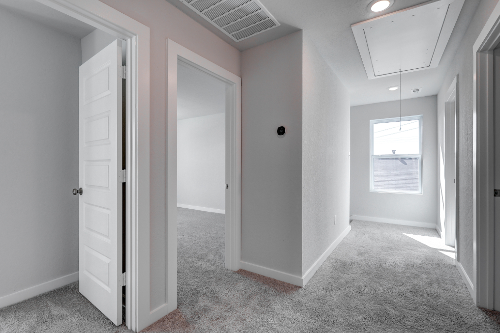 A hallway with white doors.