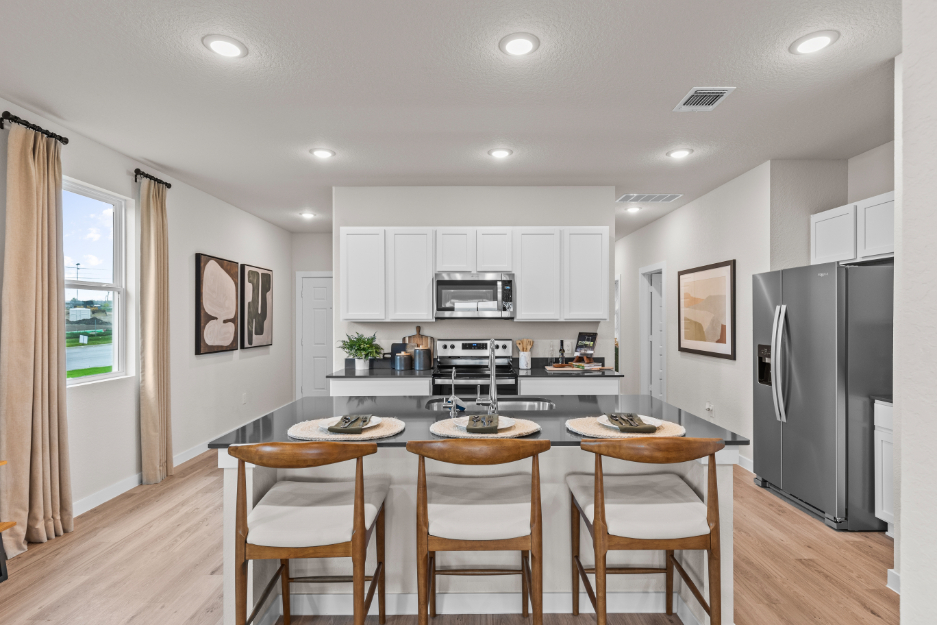 A kitchen with a dining table.