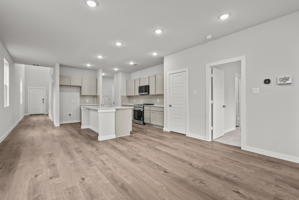 A kitchen with white cabinets.