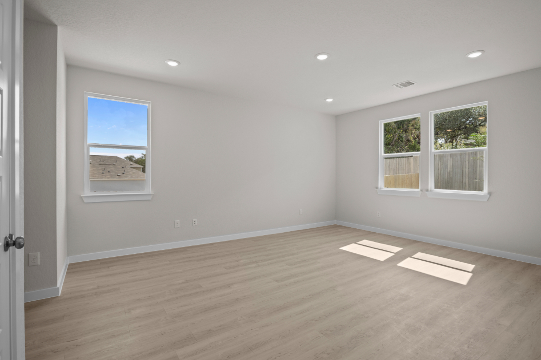 A room with a wood floor and a window.