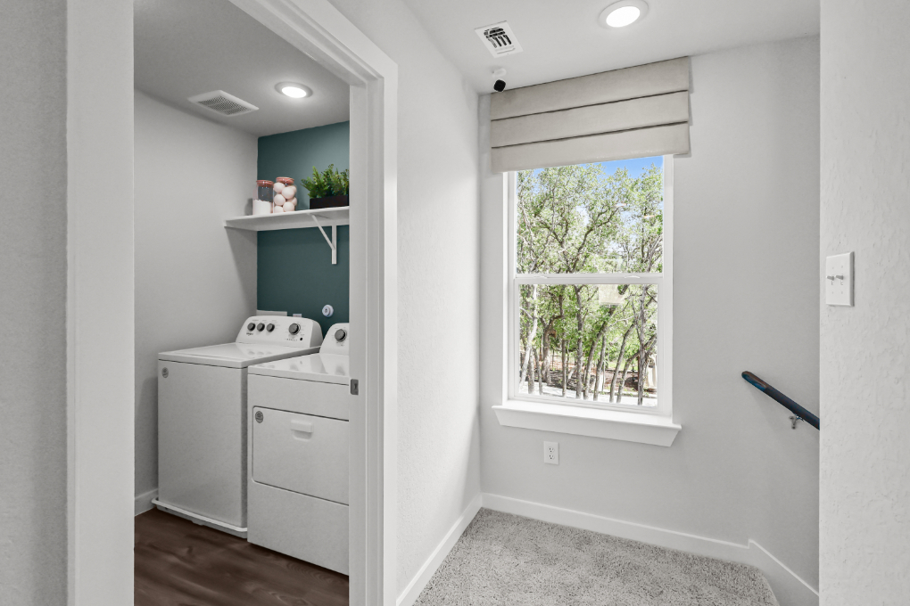 A white kitchen with a window.