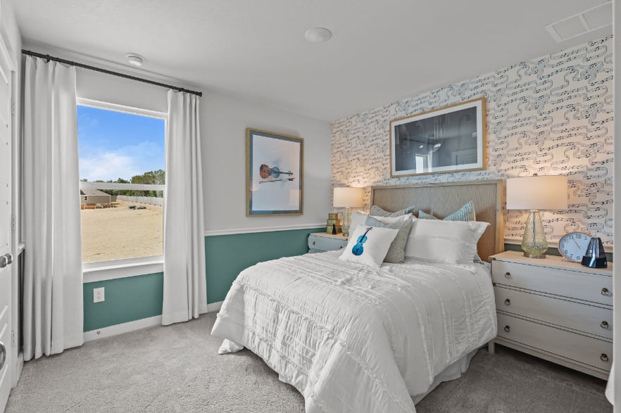 A bedroom with a large window.