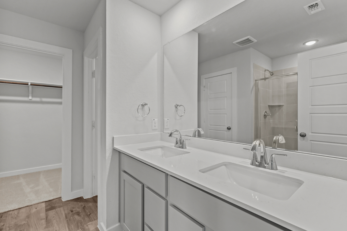 A bathroom with a large mirror.