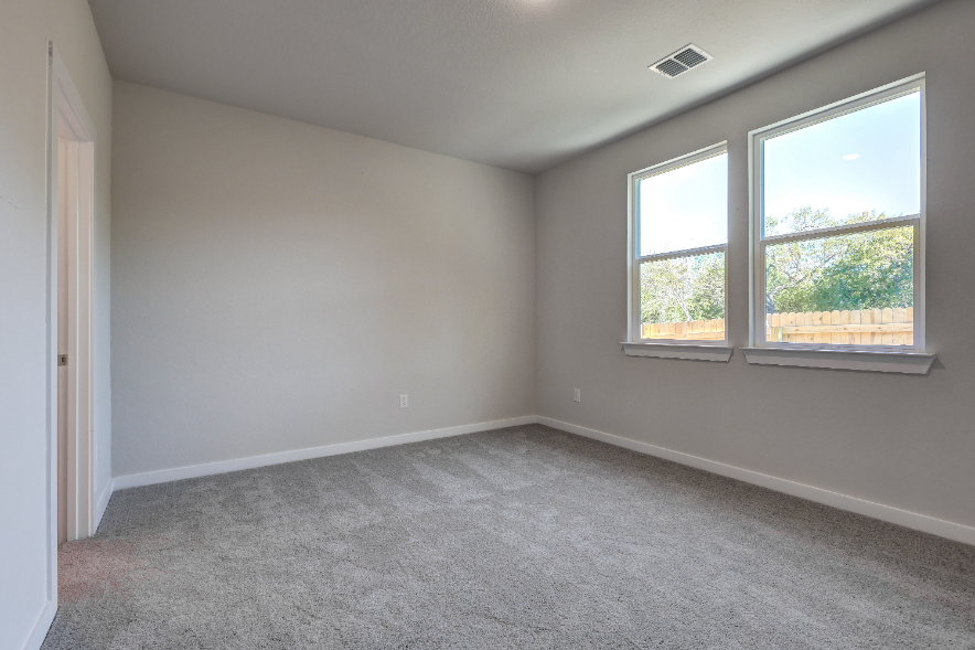 A room with windows and a carpet.