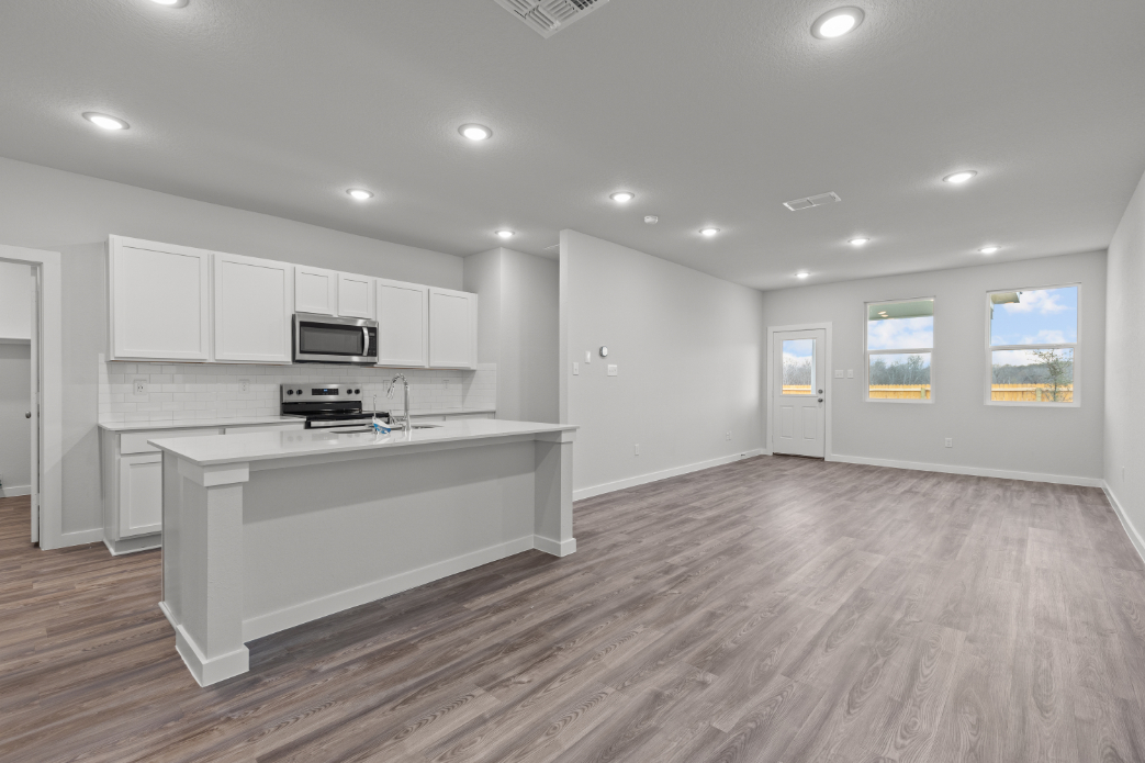 A kitchen with white cabinets.