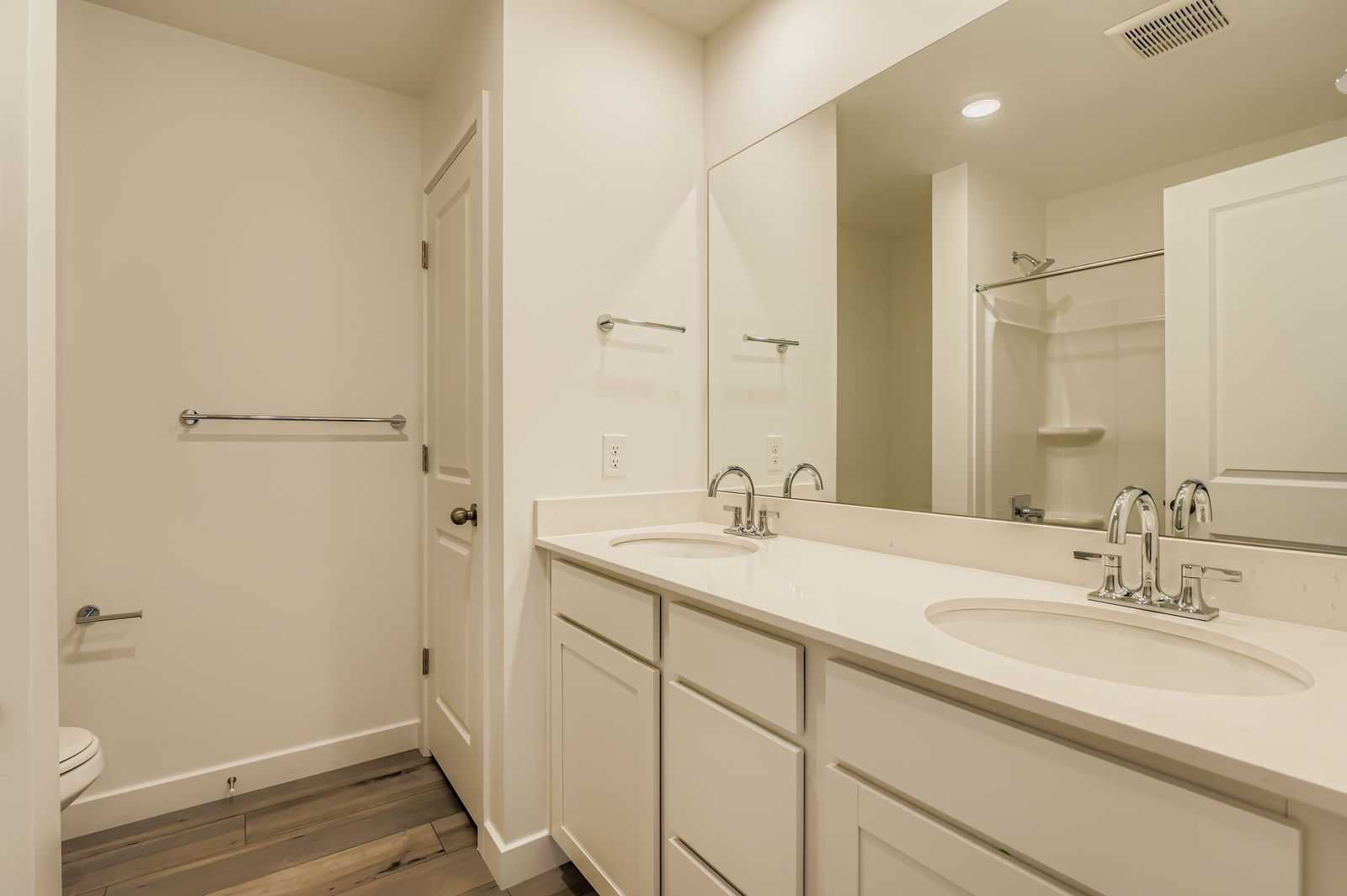 A bathroom with a large mirror.