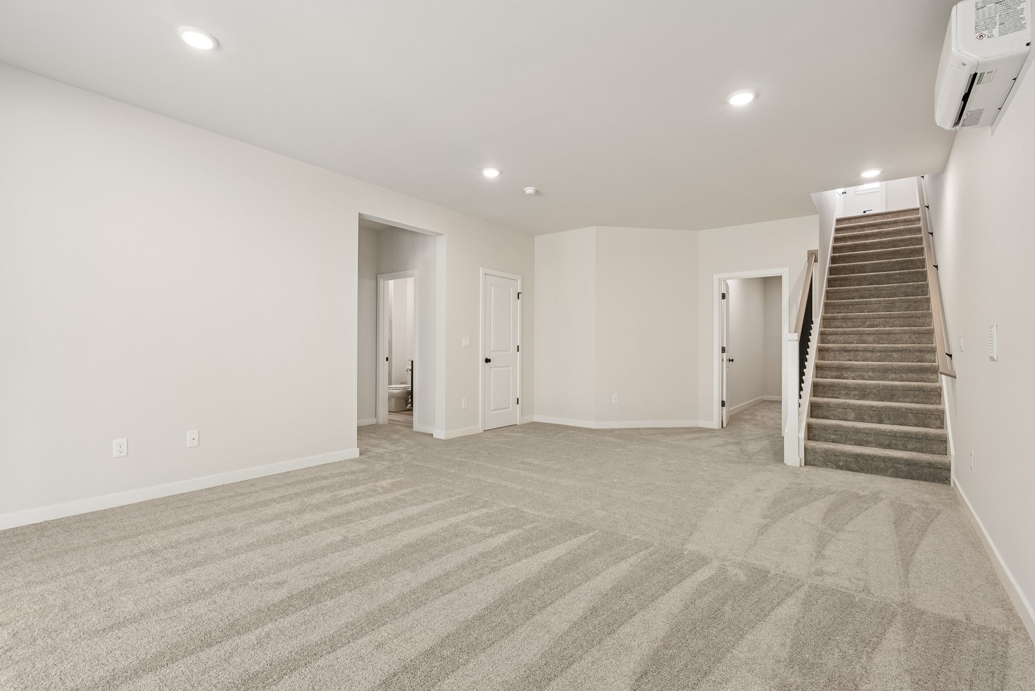 A long hallway with white walls.