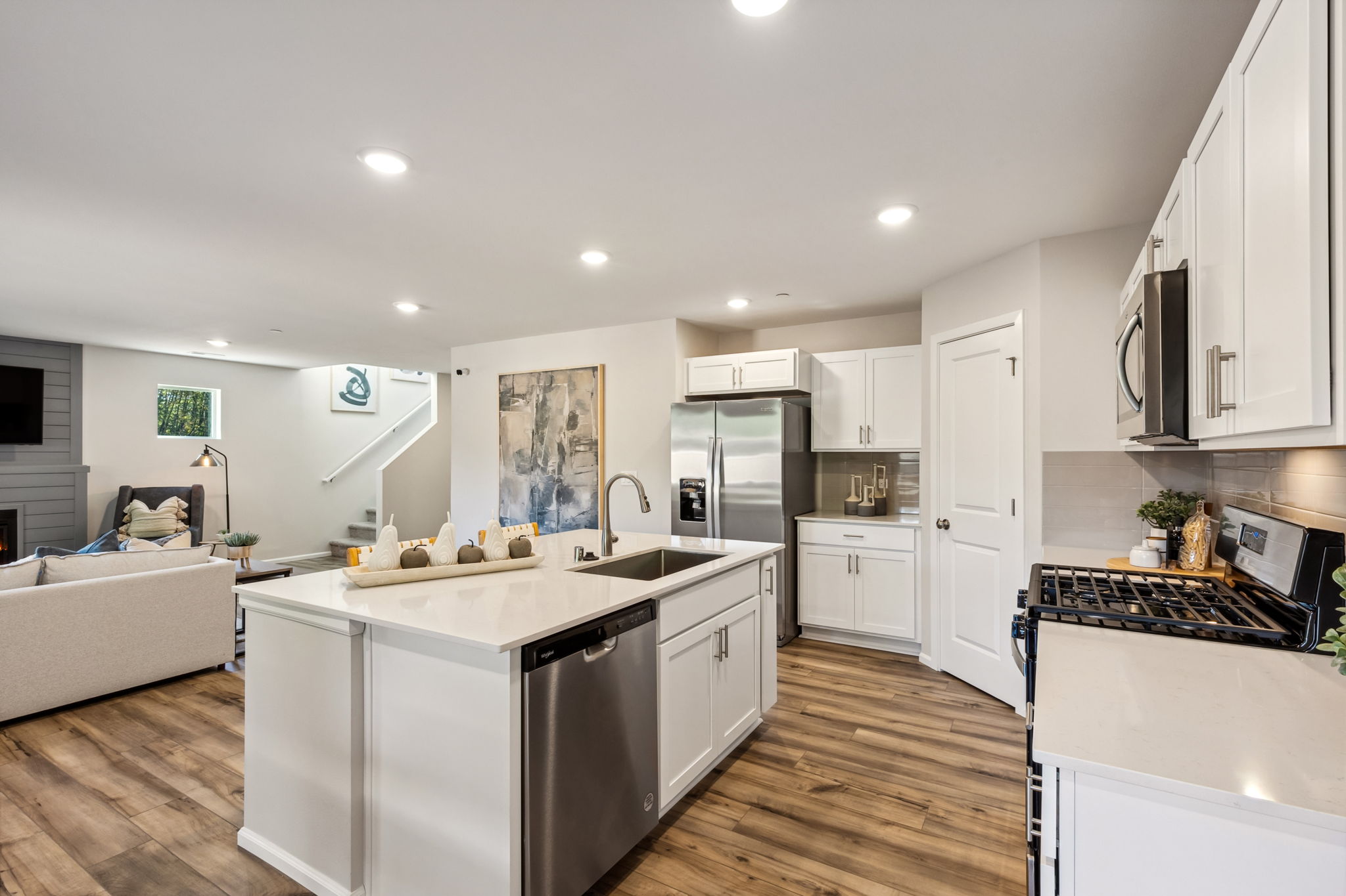 A kitchen with white cabinets.