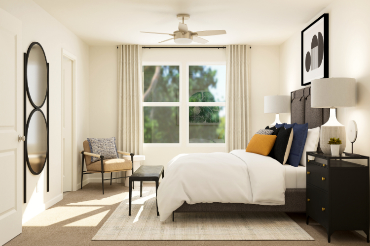 A bedroom with a bed and a fan.