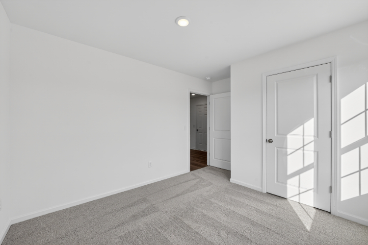 A hallway with white doors.