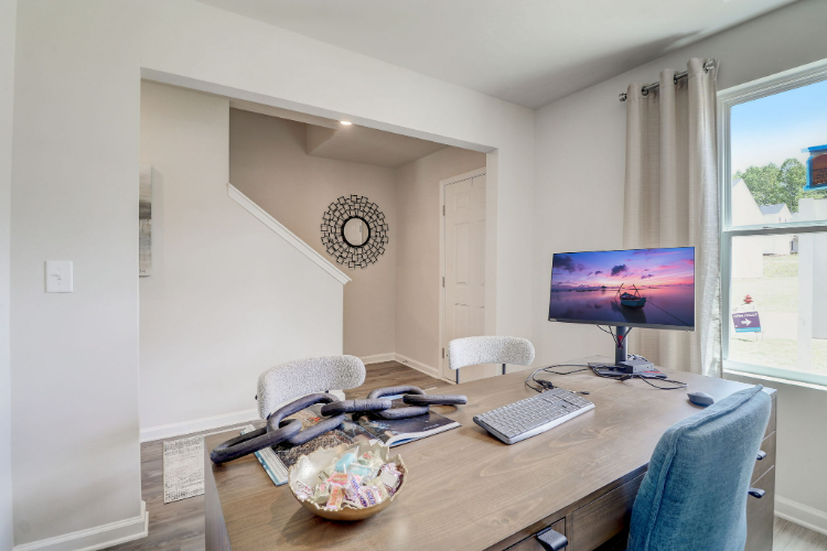 A room with a desk and a computer.