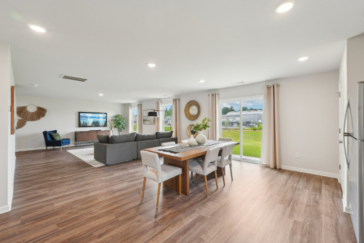 A large living room with a wood floor.