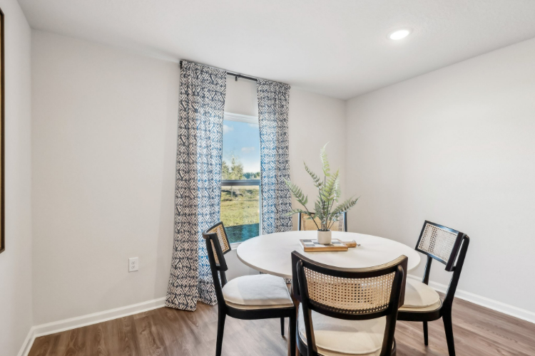A dining room table with chairs.