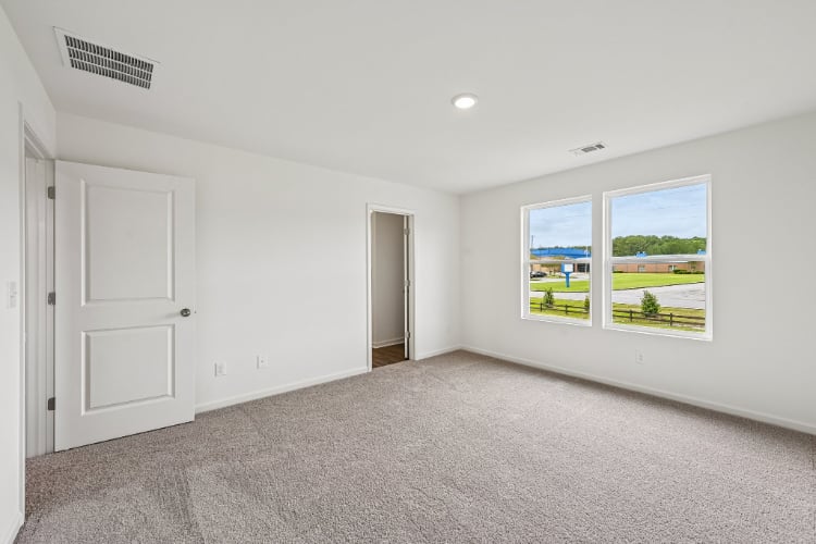 A room with white walls and a window.