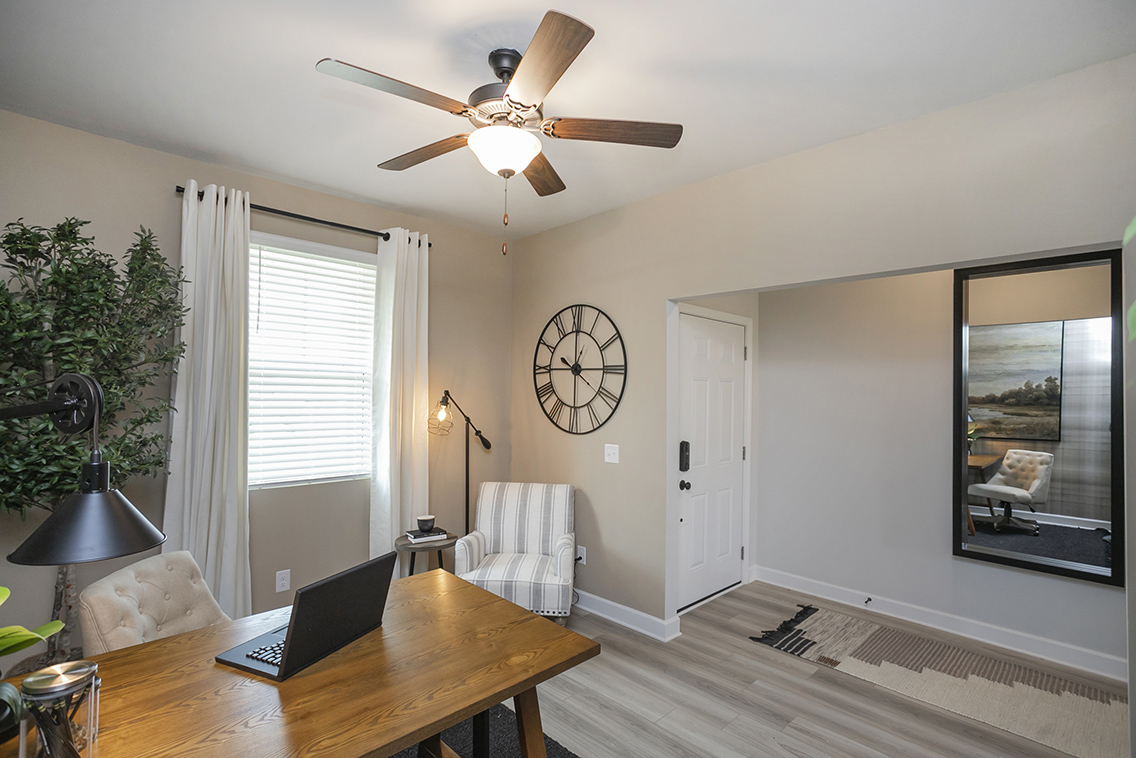 A living room with a laptop on a table.
