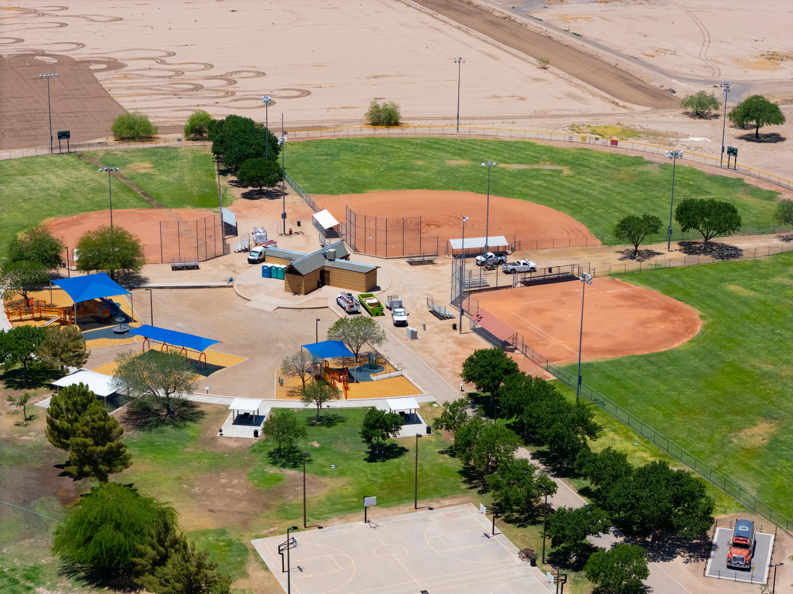 A large field with a few buildings.