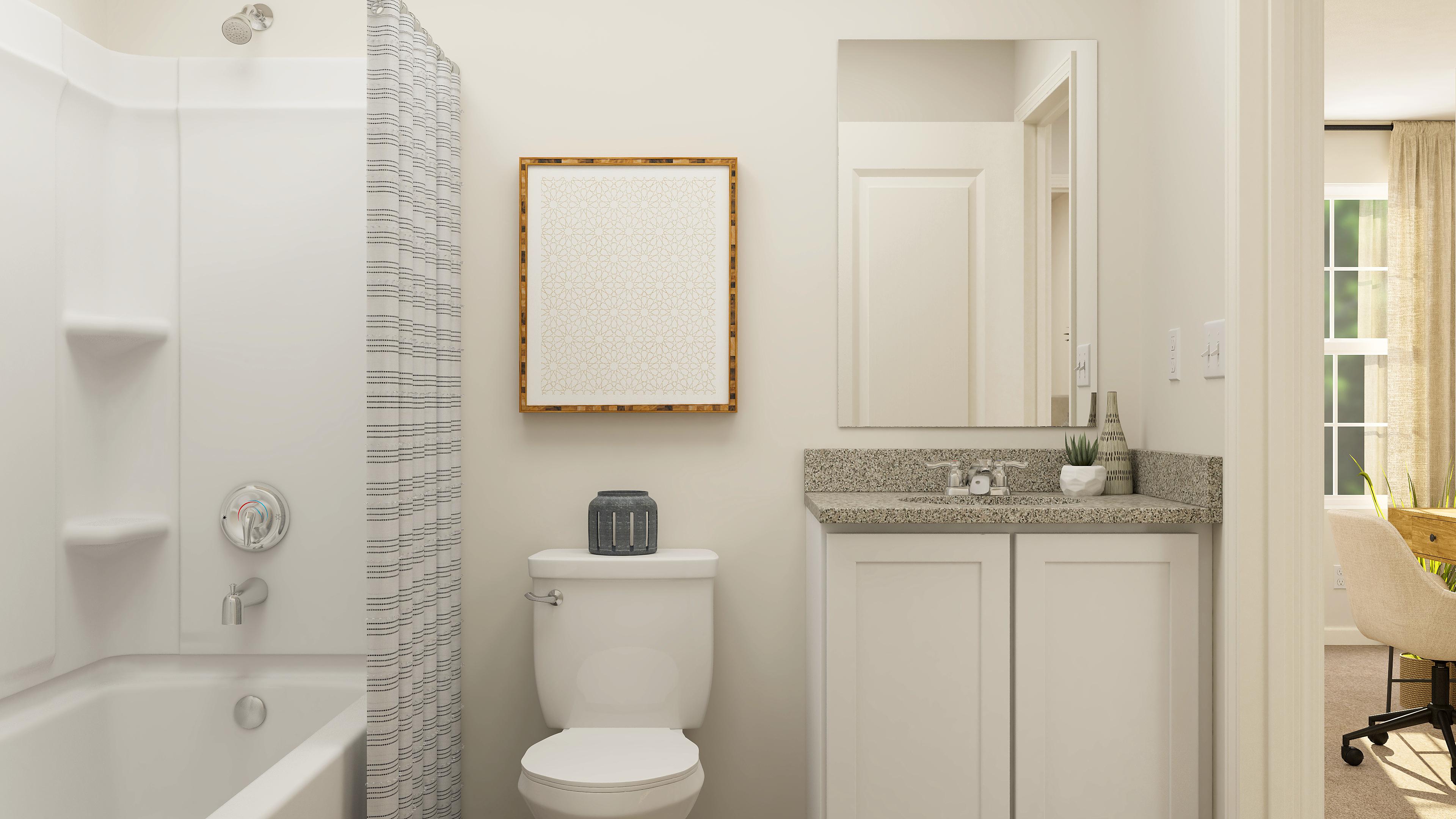 A bathroom with a tub sink and toilet.