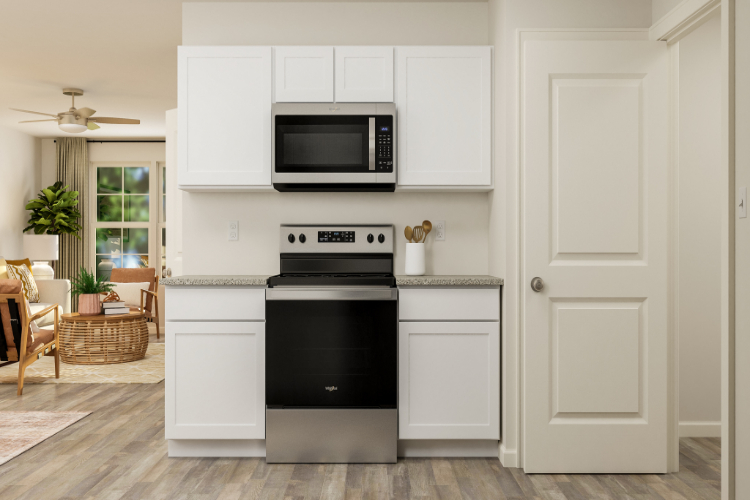 A kitchen with white cabinets.