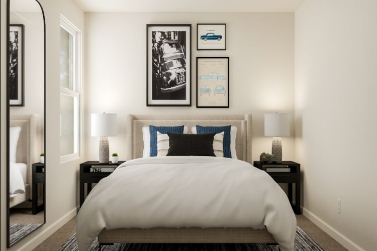 A bed with a blue and white comforter.