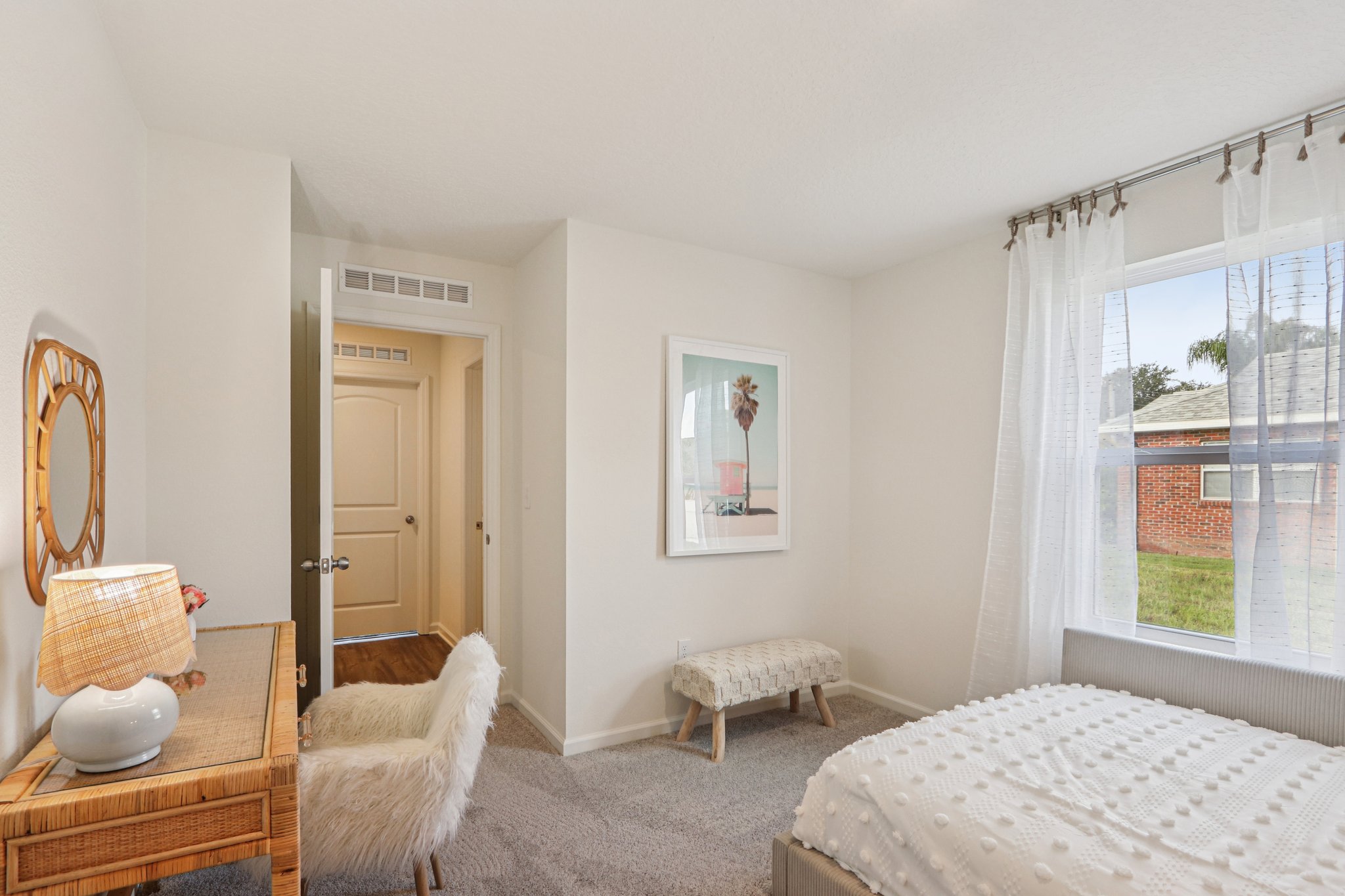 A bedroom with a bed and a chair.