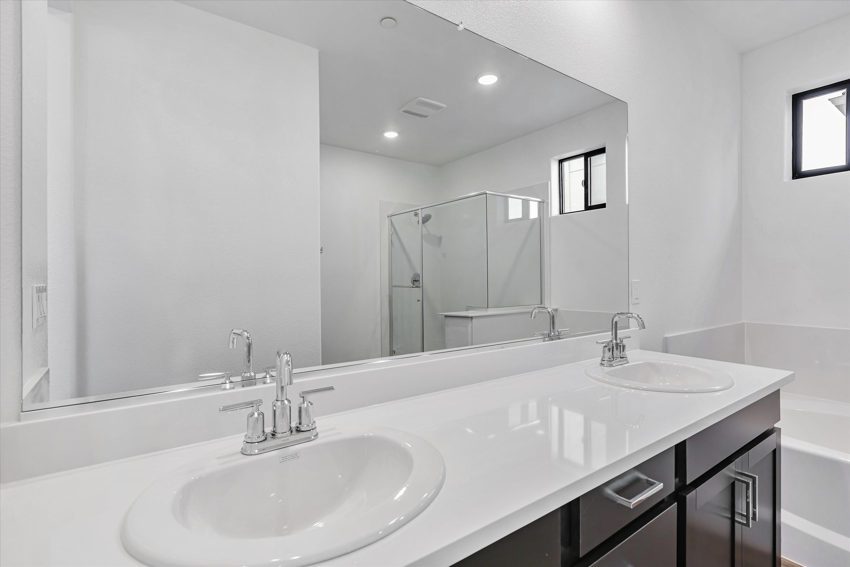 A bathroom with a large mirror.
